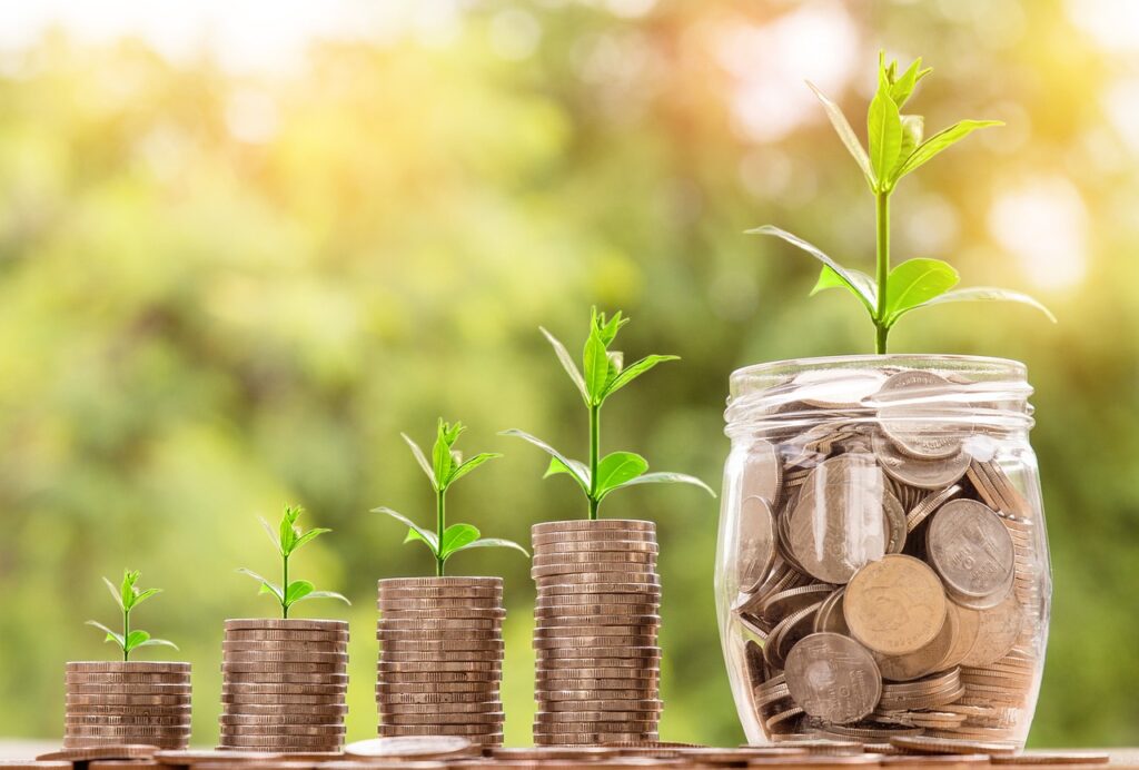 Jars of money growing representing a small plant growing into a larger plant.